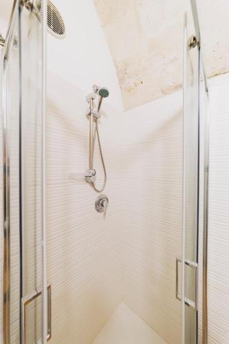 a shower with a shower head in a bathroom at Dimora Castelvecchio-Sassi Di Matera in Matera