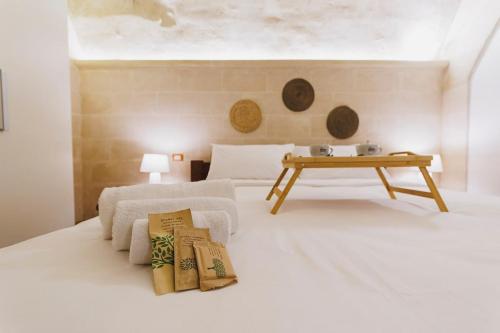 a bedroom with a bed with a table on it at Dimora Castelvecchio-Sassi Di Matera in Matera
