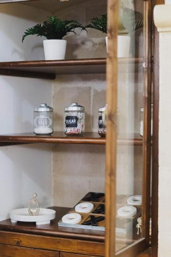 a glass shelf with toiletries on it at Dimora Castelvecchio-Sassi Di Matera in Matera