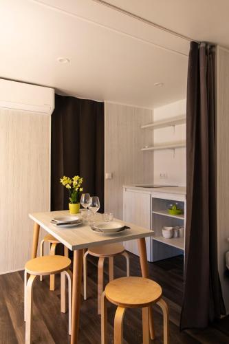 a dining room with a table and two chairs at Camping Rose in Dormelletto