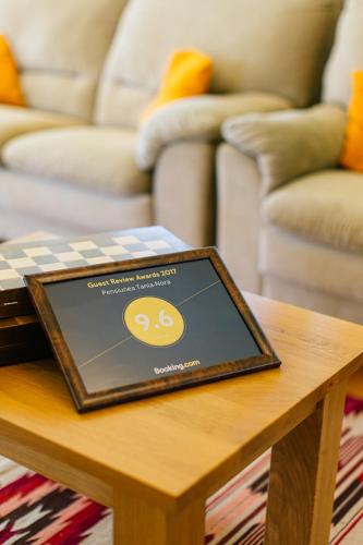 a tablet on a coffee table in a living room at Pensiunea Tania-Nora in Alexandru cel Bun 