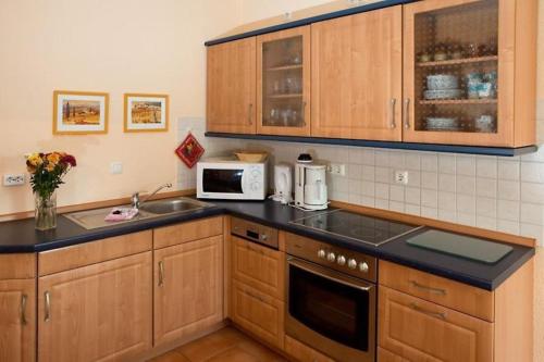 a kitchen with a sink and a microwave at Störtebeker 07 in Kühlungsborn