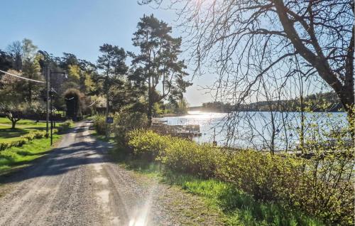 a dirt road next to a body of water at Nice Home In Värmdö With Sauna in Värmdö