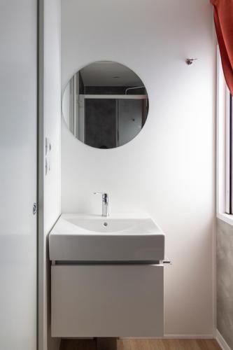 a bathroom with a white sink and a mirror at Camping Rose in Dormelletto