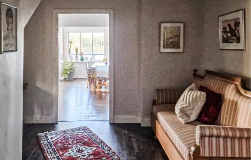 a living room with a couch and a table at Nice Home In Värmdö With Sauna in Värmdö