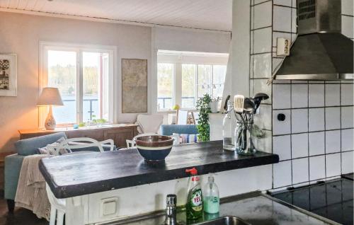 a kitchen with a counter top and a living room at Nice Home In Värmdö With Sauna in Värmdö