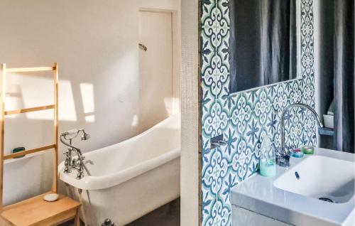 a bathroom with a tub and a sink and a bath tub at Nice Home In Värmdö With Sauna in Värmdö