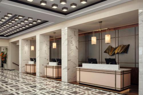 a lobby of a hotel with a reception desk at London Marriott Hotel Grosvenor Square in London
