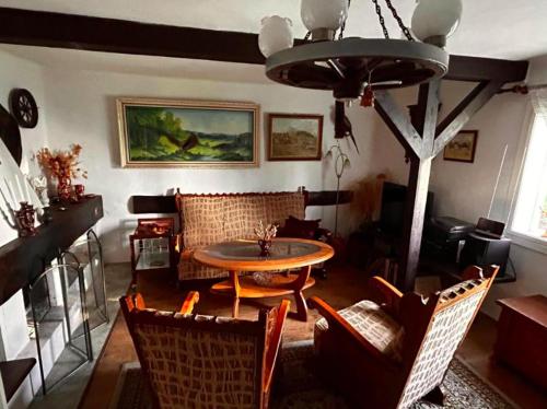 a living room with a table and chairs at chata Oáza klidu v Beskydech in Hrádek