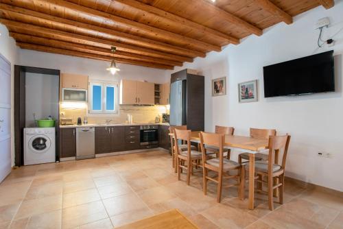 a kitchen with a table and chairs in a room at Blue Xenia Villas Paros in Chrissi Akti