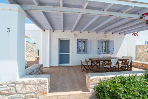 a patio with a table and chairs at Blue Xenia Villas Paros in Chrissi Akti