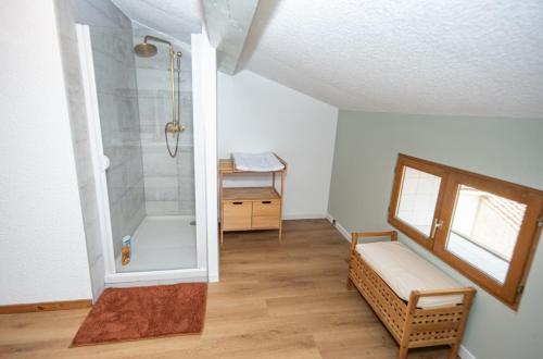 La salle de bains est pourvue d'une douche avec un banc et une table. dans l'établissement Refuge sous les toits, à Perpignan