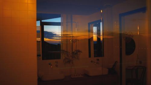 a bathroom with two sinks and a mirror at Niditas Suites & Horses in Santillana del Mar