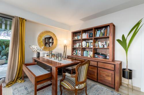 a dining room with a table and a book shelf at NICE luxury residence, Garden level with sea view and swimming pool, 2bedroom apartment of approximately 85 square meter and private garden in Nice