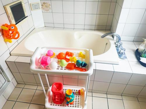 a small bathroom with a tub with toys in it at Ikaho no mori Kids Paradise in Ikaho
