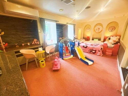 a childs room with a bedroom with a bed and toys at Ikaho no mori Kids Paradise in Ikaho