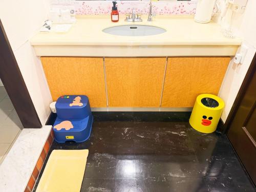a bathroom with a sink and two childrens play bins at Ikaho no mori Kids Paradise in Ikaho