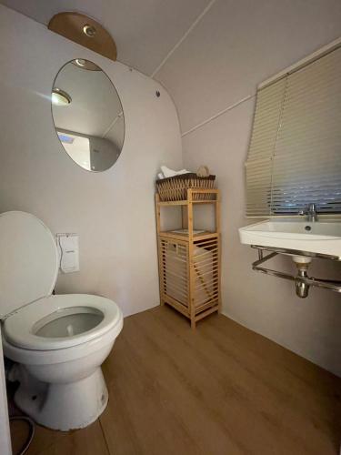 a bathroom with a toilet and a sink at TREX Buriram Boutique Hotel in Buriram