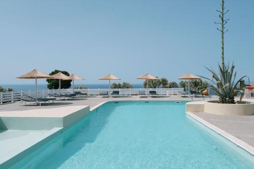 a swimming pool with a view of the ocean at Mandilada Village in Samos in Marathokampos