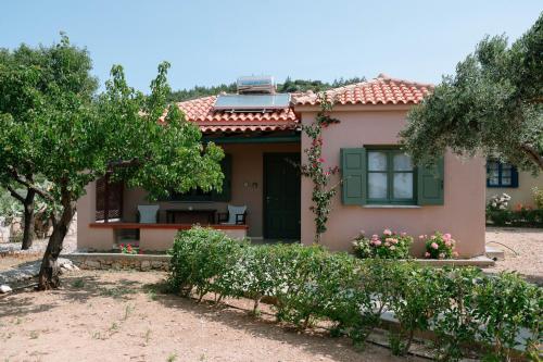 a small house with a garden and trees at Mandilada Village in Samos in Marathokampos