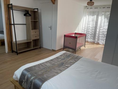 a bedroom with a bed and a dresser and a window at Gîte Belle Vue 2 in Saint-Léger-les-Mélèzes