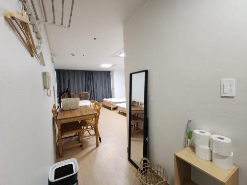 a room with a mirror and a table and a dining room at Hongdae Sky apartment in Seoul