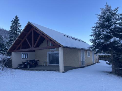 a house with snow on the ground in front of it at Gîte Belle Vue 2 in Saint-Léger-les-Mélèzes