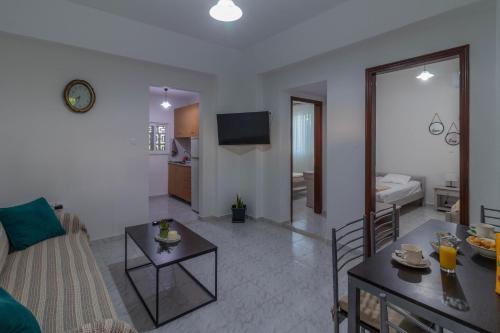 a living room with a couch and a table at Beachside Apartment-1 in Afantou