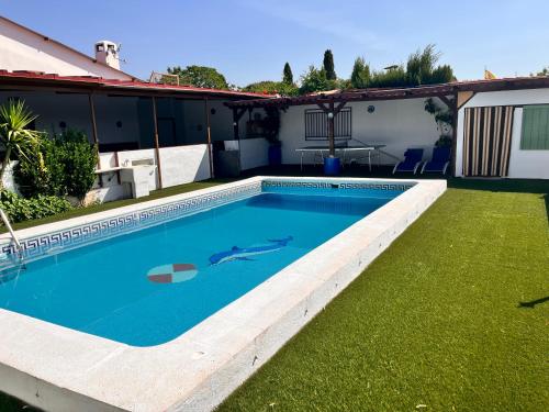 a swimming pool in the backyard of a house at Cortijo Candela in Granada