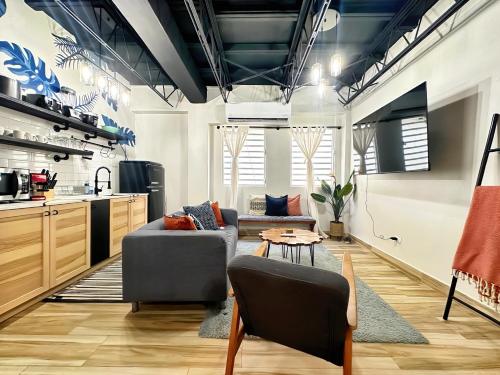 a kitchen and living room with a couch and a table at The Lofts At Santurce in San Juan