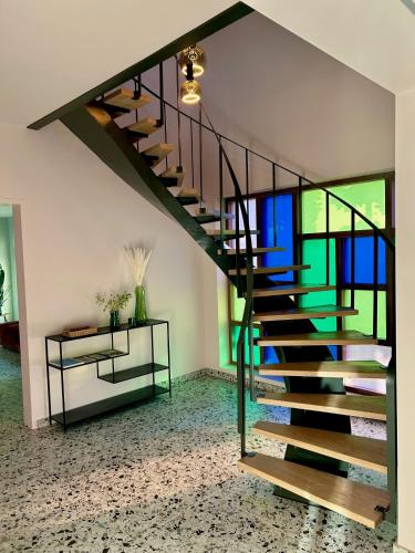 a spiral staircase in a living room with a window at Villa Couleur in Diksmuide