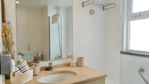 a bathroom with a sink and a mirror at MaraHomes in Funchal