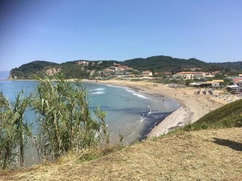 a view of a beach with people in the water at ILENIMA Hotels in Agios Stefanos