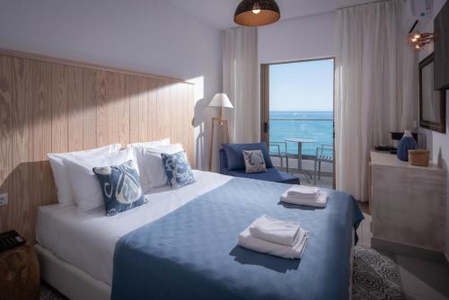 a hotel room with a bed with towels on it at Enorme Serenity Spritz - Adults Only in Hersonissos