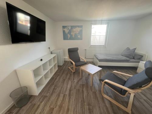 TV a/nebo společenská místnost v ubytování Monteurwohnung Giebolehausen