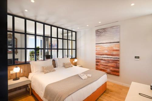 a bedroom with a bed and a large window at The Elite Corfu Luxury Apartment in Corfu