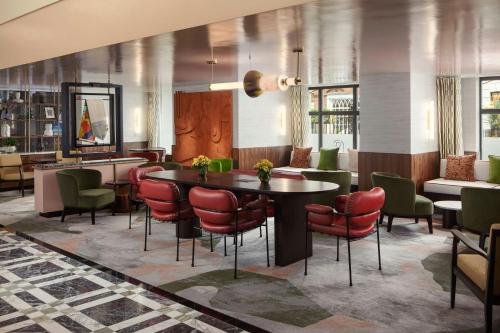 a dining room with a table and chairs at London Marriott Hotel Grosvenor Square in London