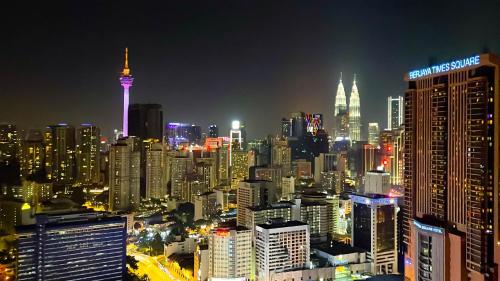 a city skyline at night with the space needle at 1BR condo with Amazing KLCC View & Infinity Pool at Lalaport Bukit Bintang in Kuala Lumpur