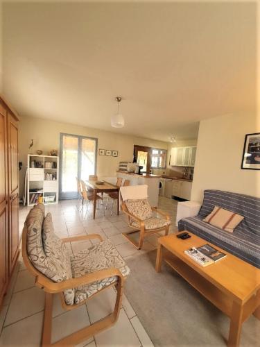 un salon avec un canapé et une table dans l'établissement maison residence les arros, à Soulac-sur-Mer