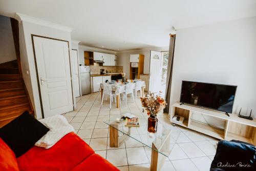 a living room with a red couch and a table at Grand Hotel Des Bains & Villas des Bains in Vals-les-Bains