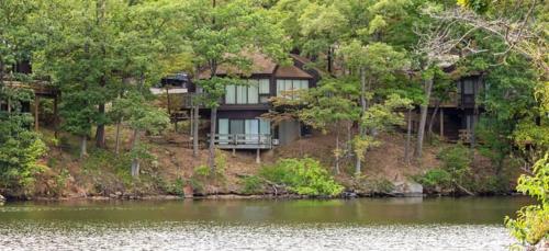 a large house on the side of a river at Treetop 3bd3badeckpoolsgrilldock-sleeps 8pp in Four Seasons