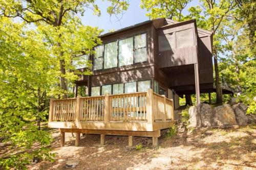 a house sitting on top of a tree at Treetop Village51-3bed3bapools-8pp in Four Seasons