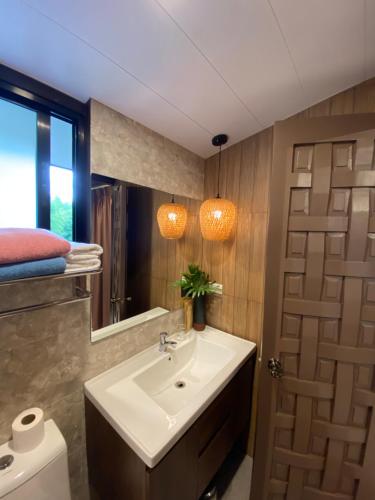 a bathroom with a sink and a mirror at Altamers Mountain Resort 