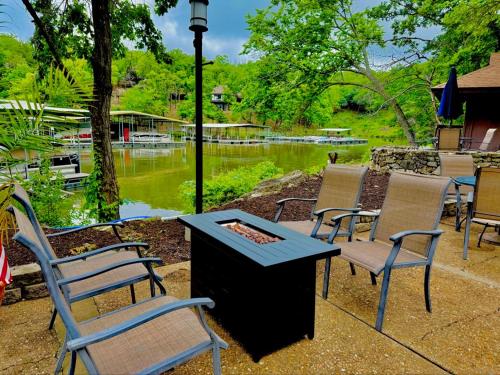 a group of chairs and a table with a fire pit at Treetop Village51-3bed3bapools-8pp in Four Seasons