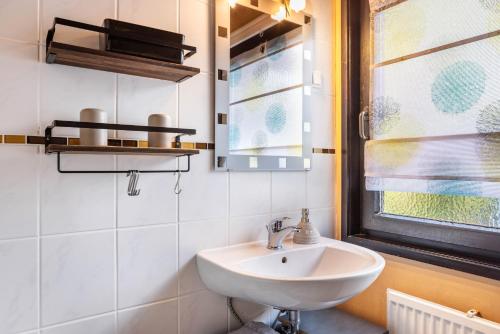 a bathroom with a sink and a window at Ferienhaus Sweet Home in Ronshausen