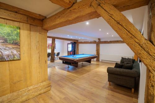 a living room with a pool table in it at Müllerjörgenhof in Gutach