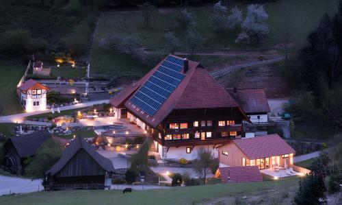 a large house with solar panels on the roof at night at Müllerjörgenhof in Gutach