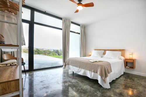 a bedroom with a bed and a large window at Villa Guadiana Golf 2 in Ayamonte