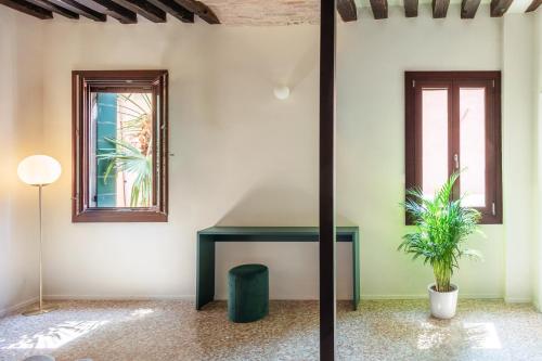 a room with a table and two windows at QN Apartments in Venice