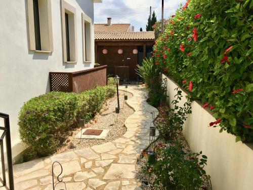 a garden with a stone walkway in front of a house at Villa Panorama - Stunning views in villa with hot tub, pool, garden in Kouklia